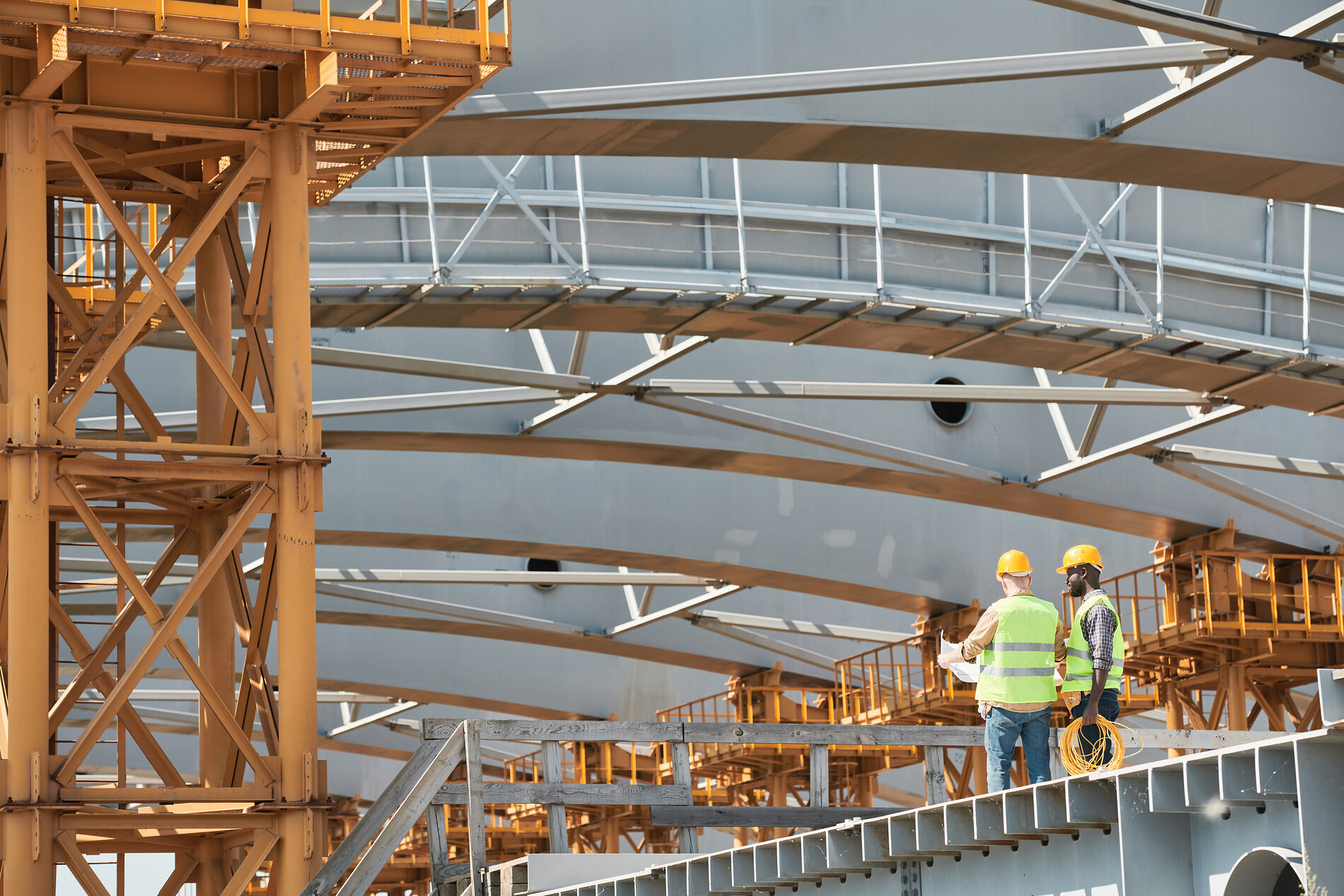 Construction workers reviewing blueprints on a jobsite