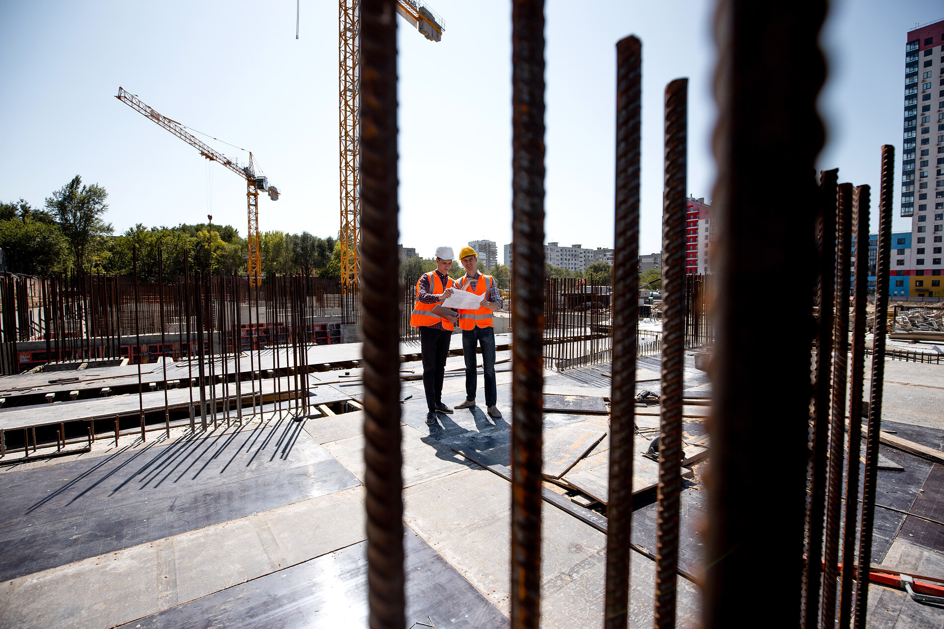 Construction workers reviewing plans on site